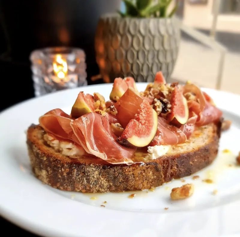 A fig, prosciutto and walnut toast on sourdough at Yard, drizzled with honey.