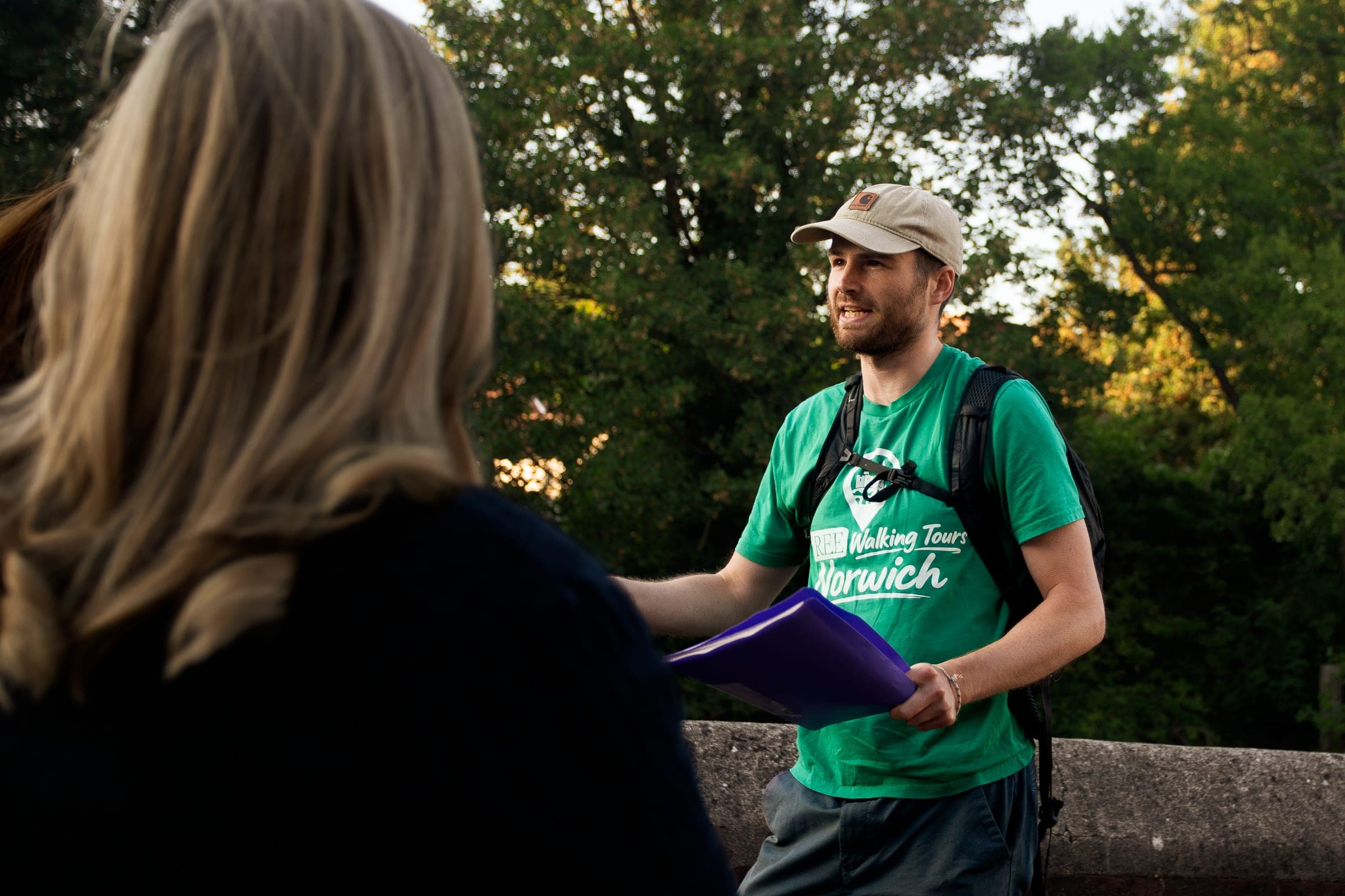 Tom talking to guests beside the River Wensum at Fye Bridge