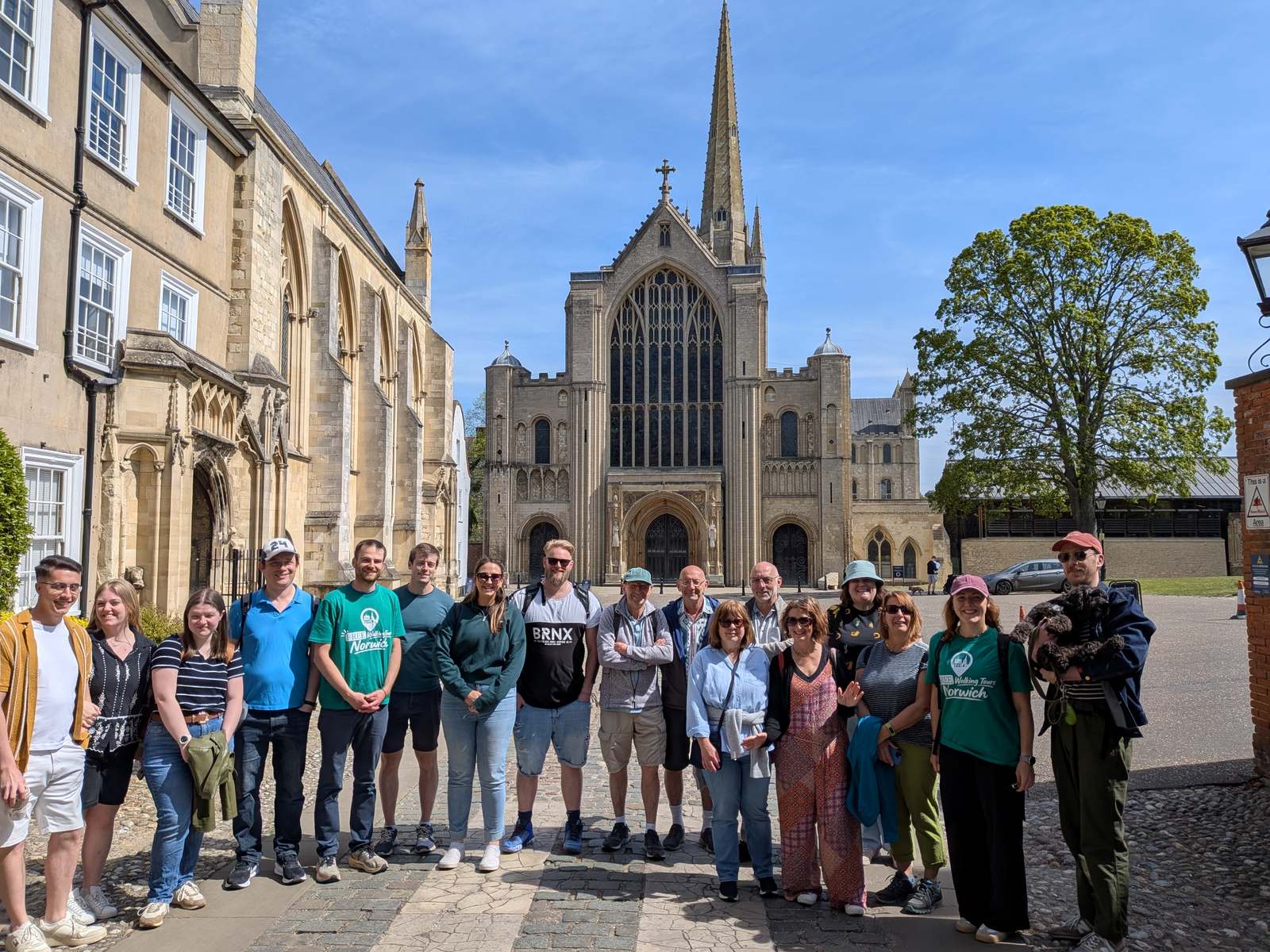 Walking tour group outside the west front of Norwich Cathedral