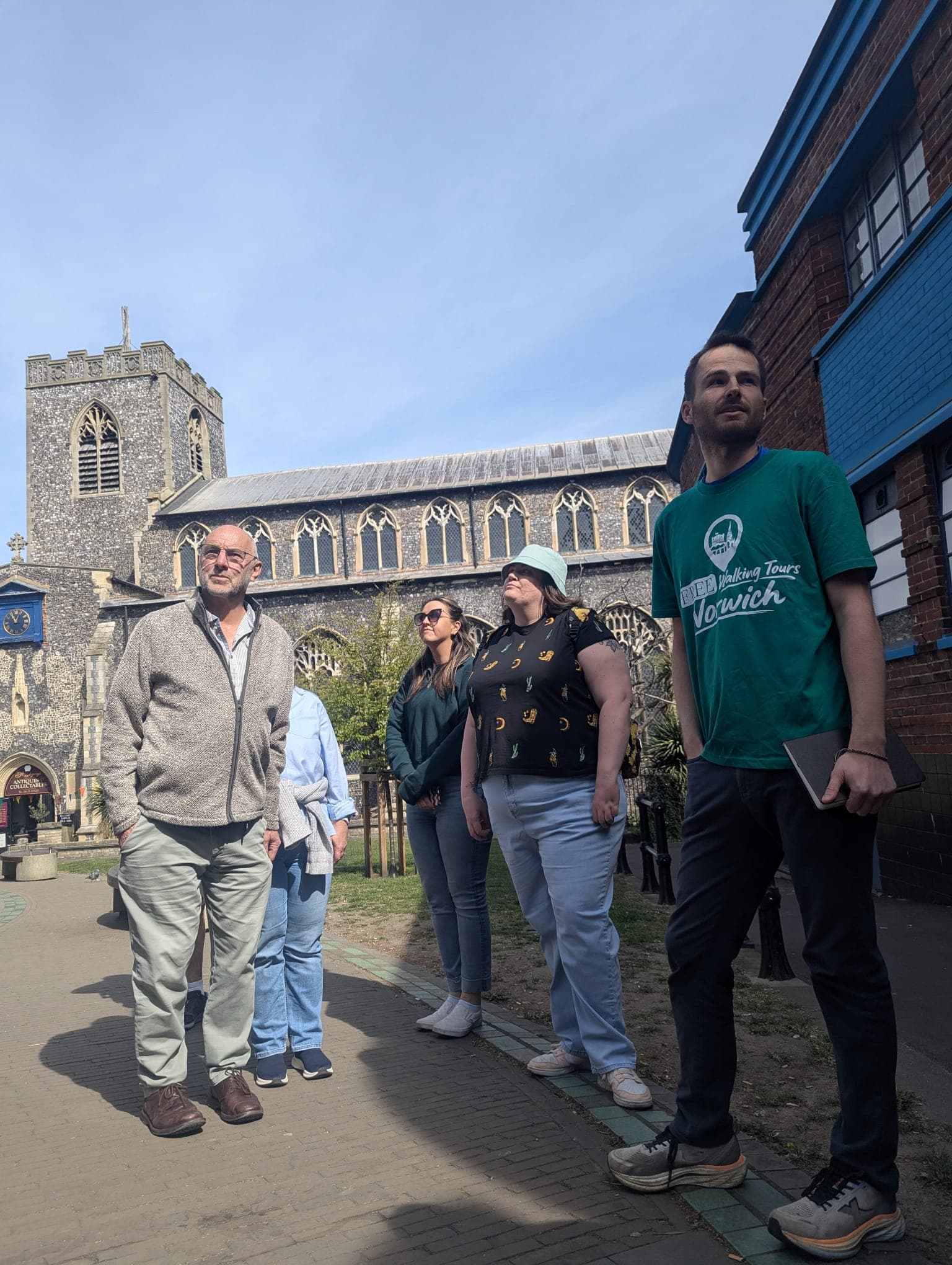 Norwich Free Walking Tour group walking together with their guide, mid-tour
